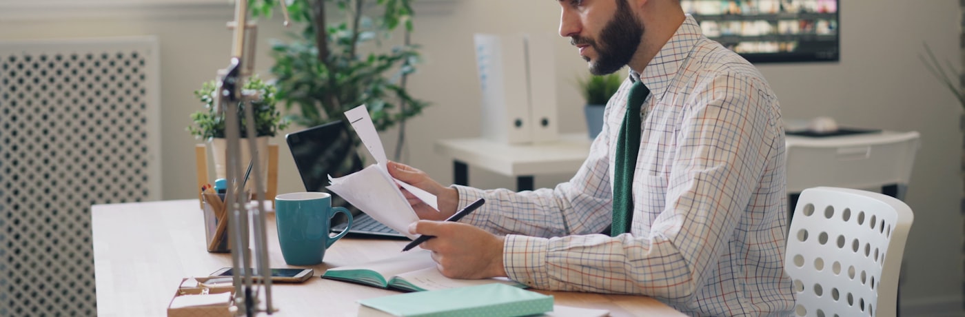 A professional reviewing documents at a calm desk